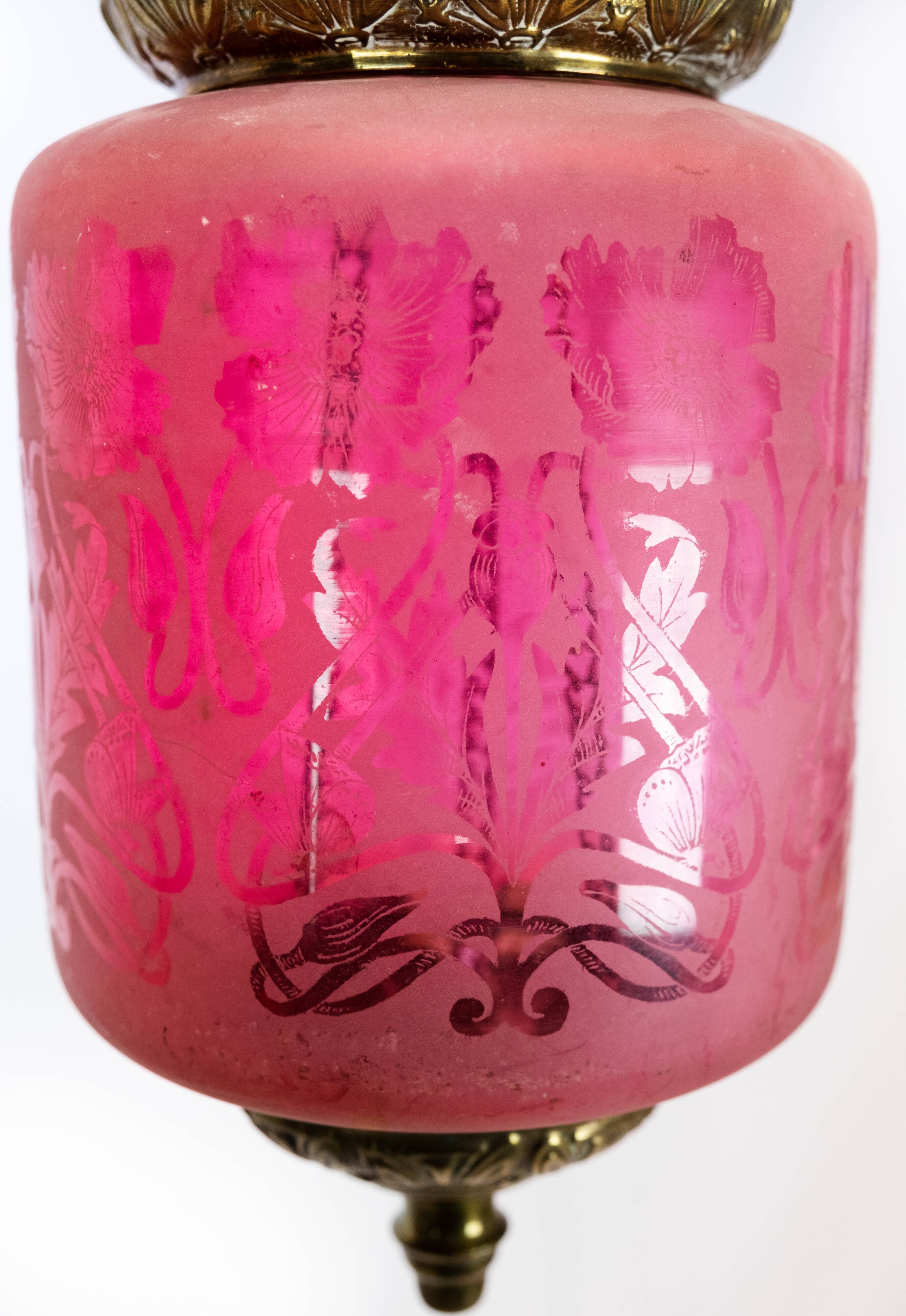 Antique pendant of pink opaline glass with brass edge and suspension from around 1860