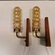 A set of Danish wall lights in champagne coloured glass with brass and teak.