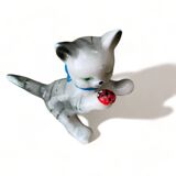 Little ceramic cat playing with a playful ladybug plays gray and white decoration