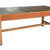 Large industrial workshop table in brown wood, wide top and sturdy vintage legs.