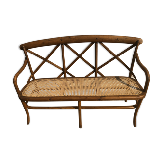 Curved wooden bench and cannage