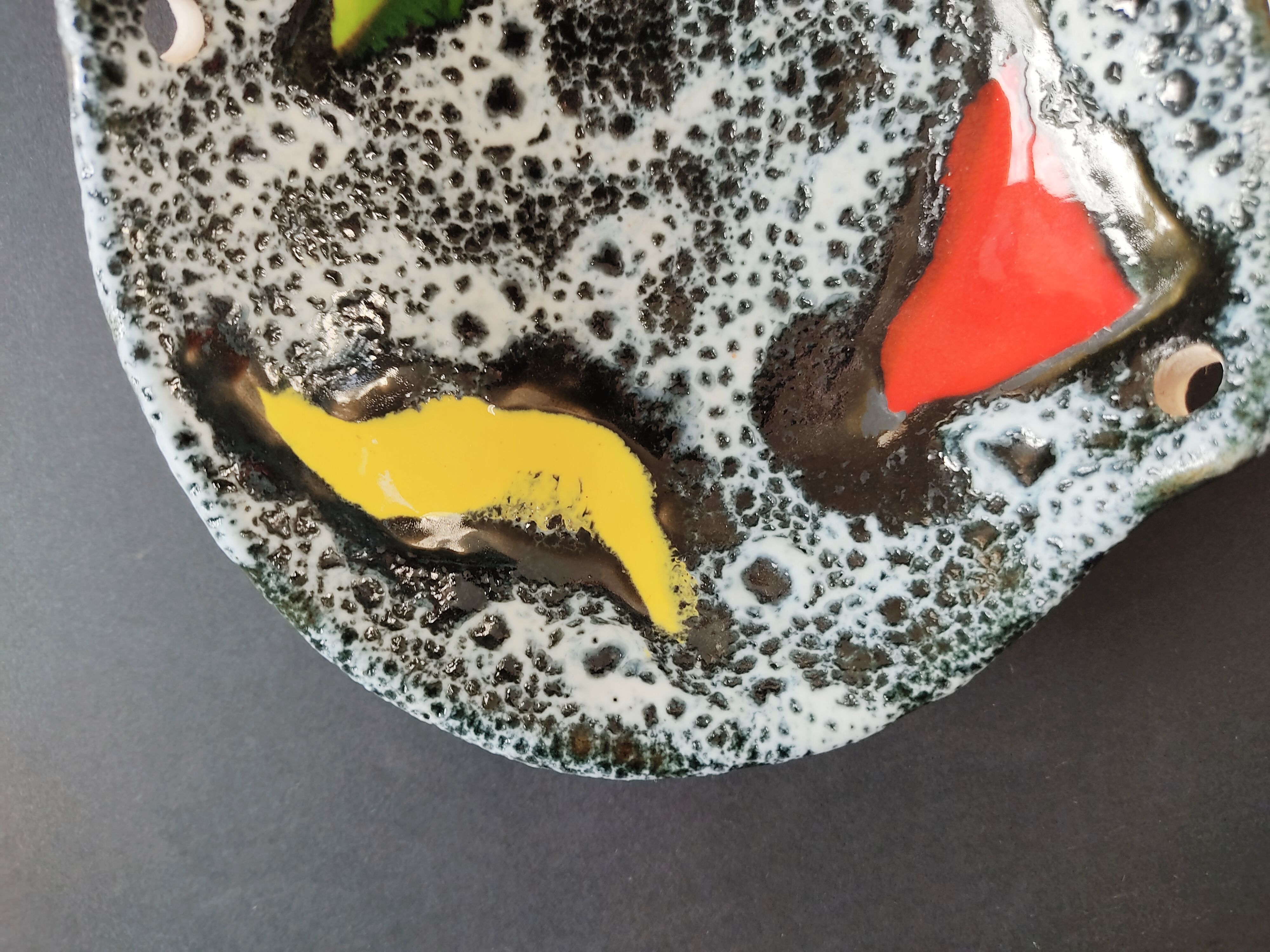 Empty black and white pocket with colored enamels