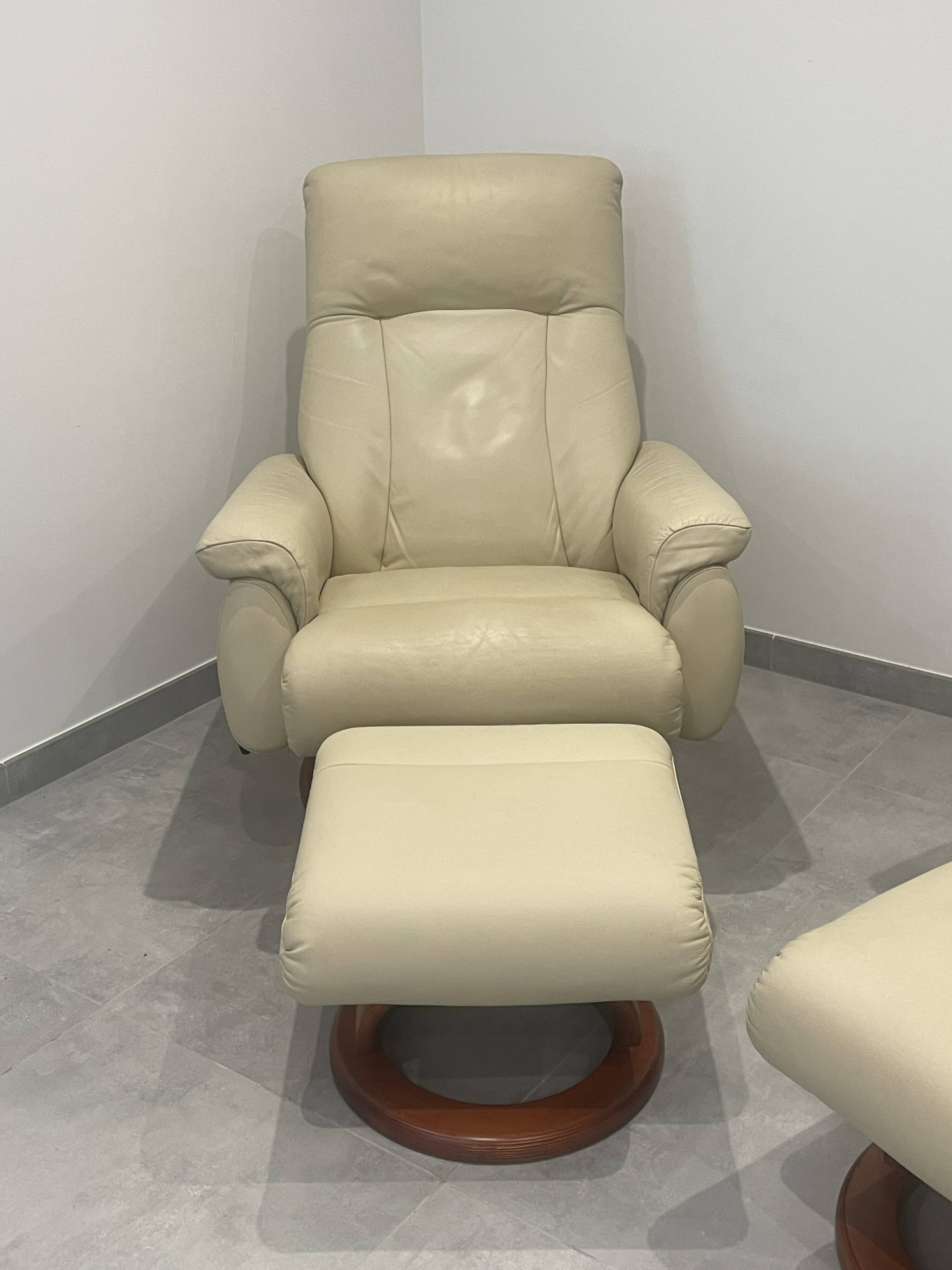 Pair of vintage leather armchairs with ottoman