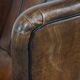 Vintage sheepskin wingback chair finished with black piping