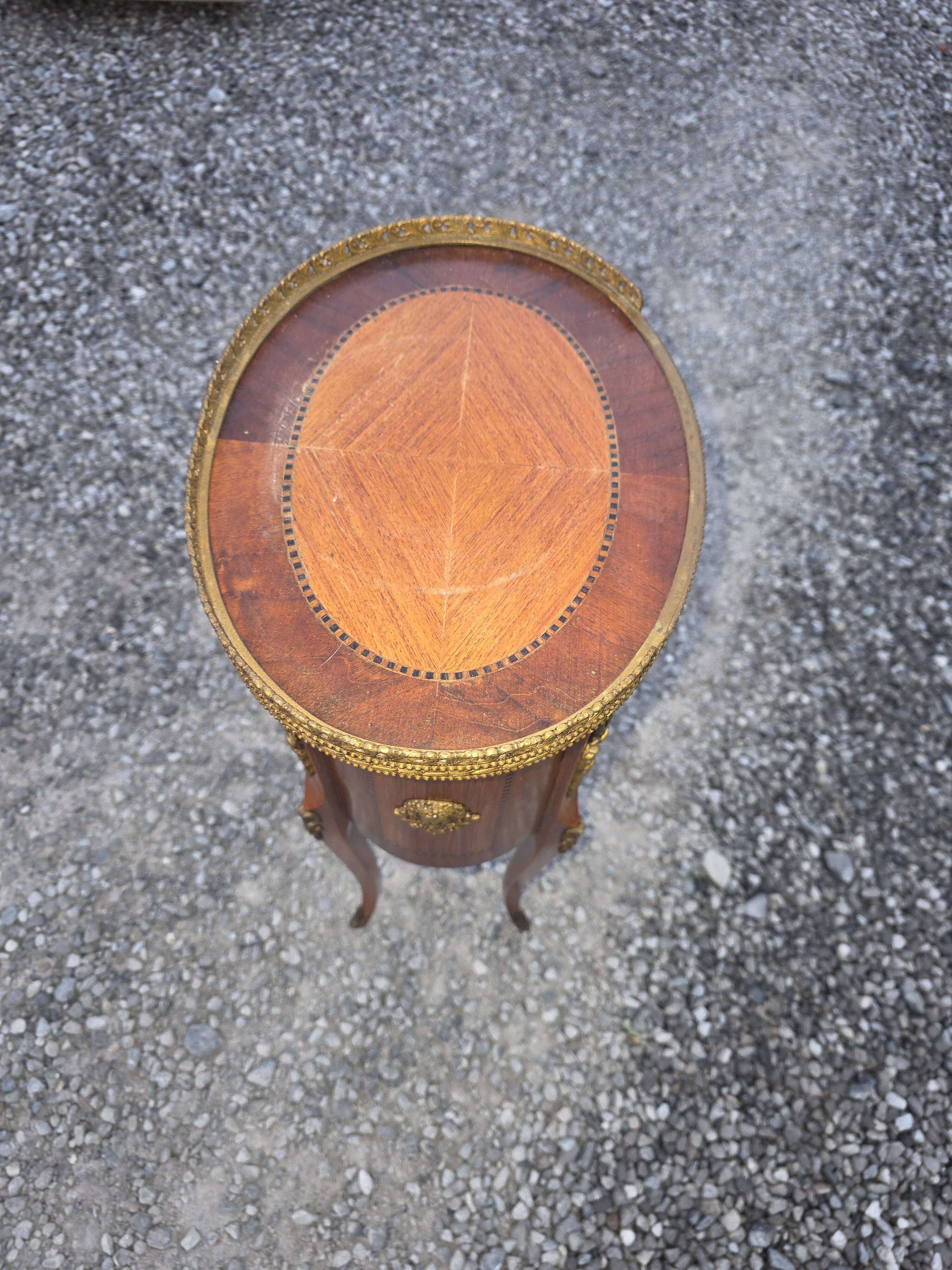 Oval bedside table in Louis XV style with marquetry.