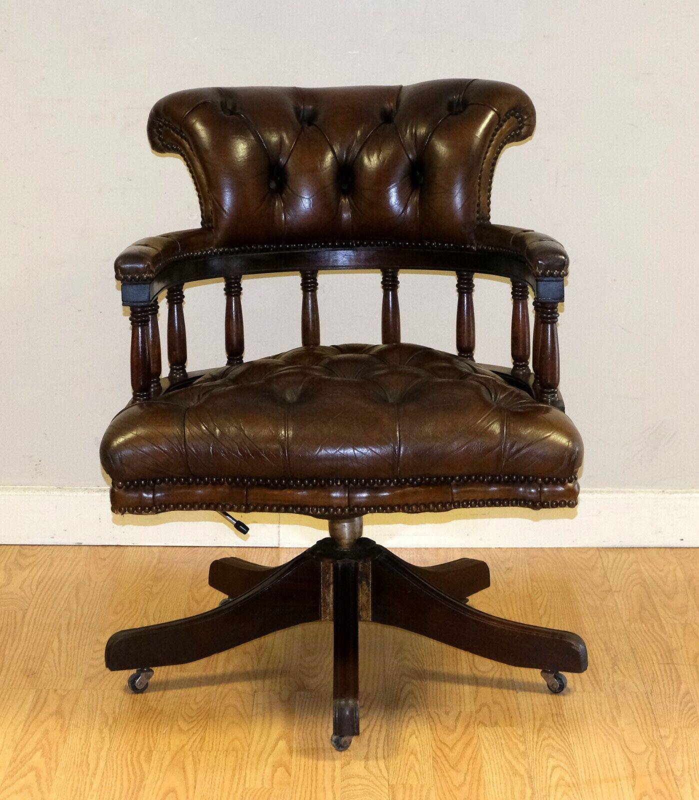 Restored Chesterfield captain's armchair in leather with an oak frame.