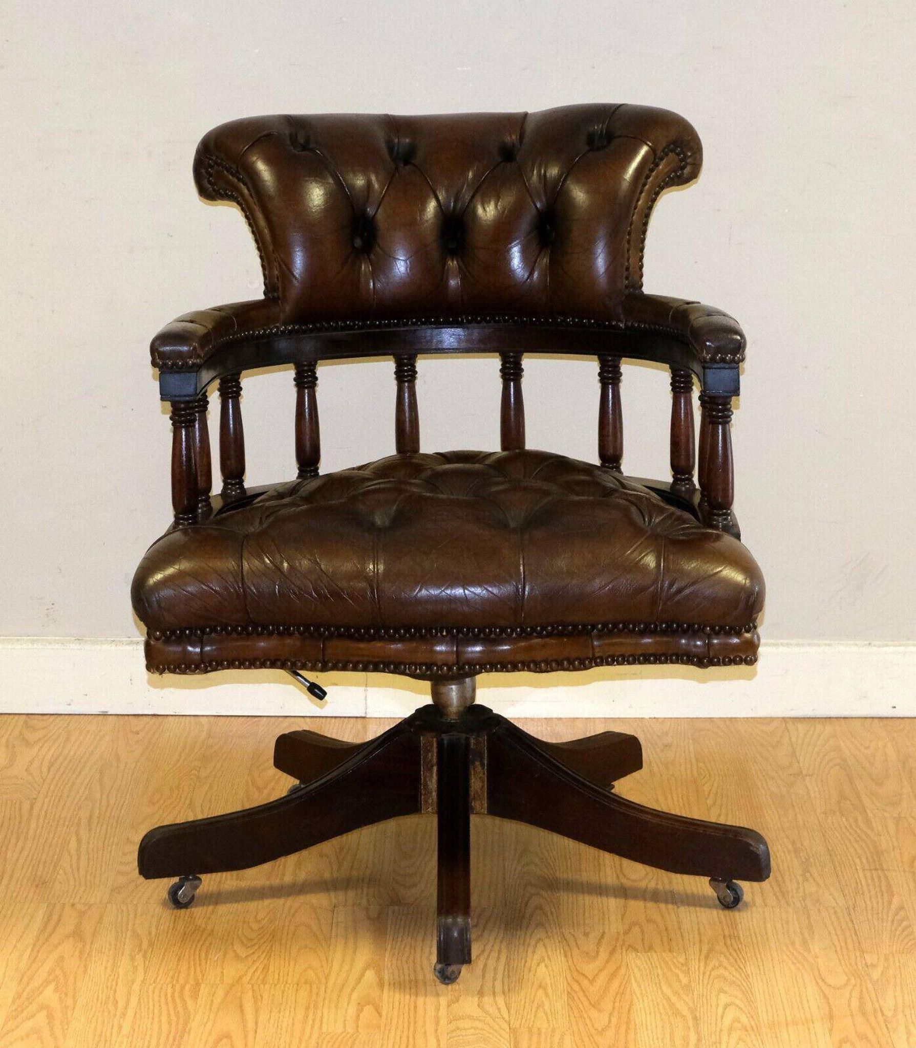 Restored Chesterfield captain's armchair in leather with an oak frame.