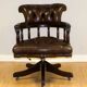 Restored Chesterfield captain's armchair in leather with an oak frame.
