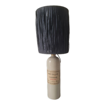 Lampe bouteille en gres abat jour en raphia noir