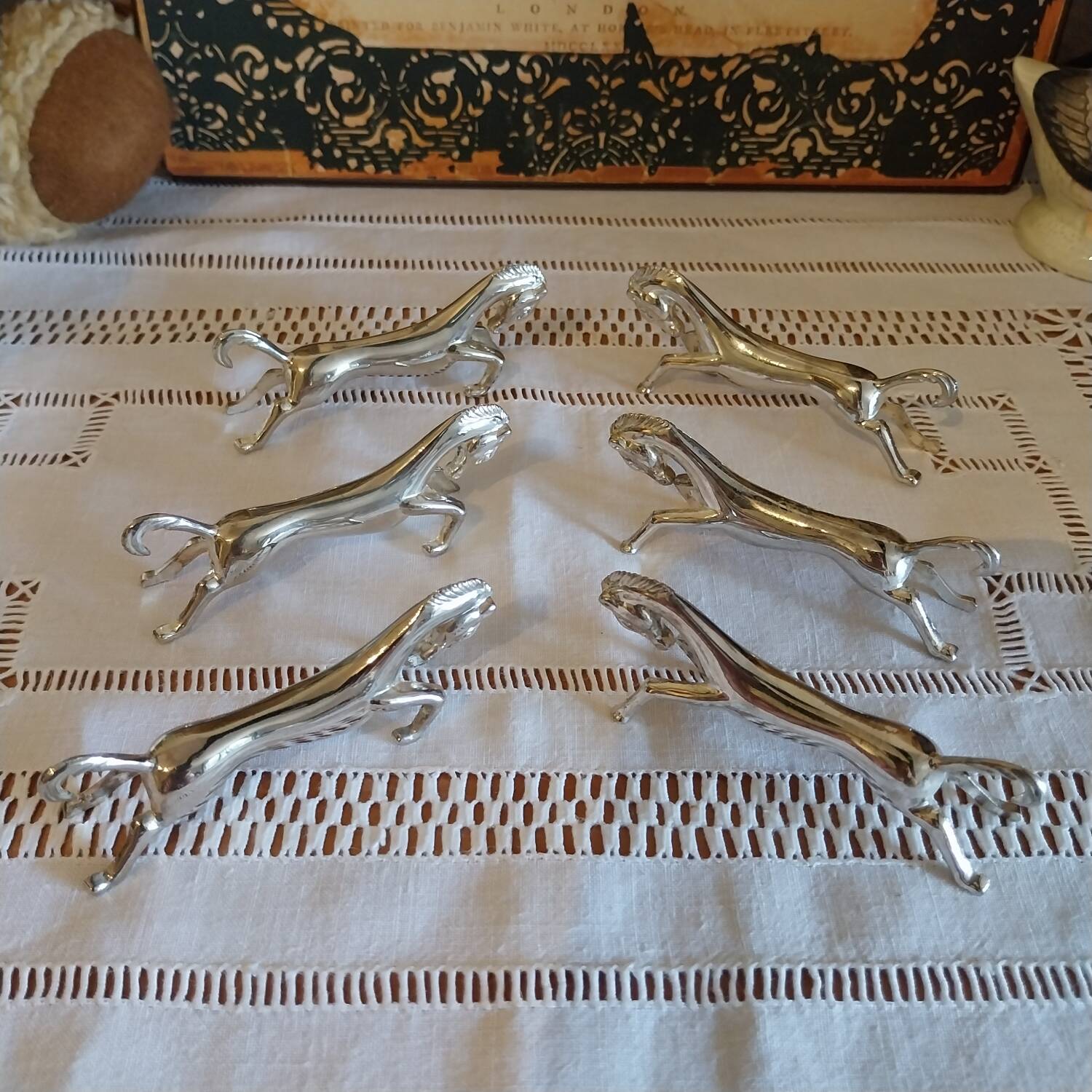 Silver metal horse-shaped knife rests