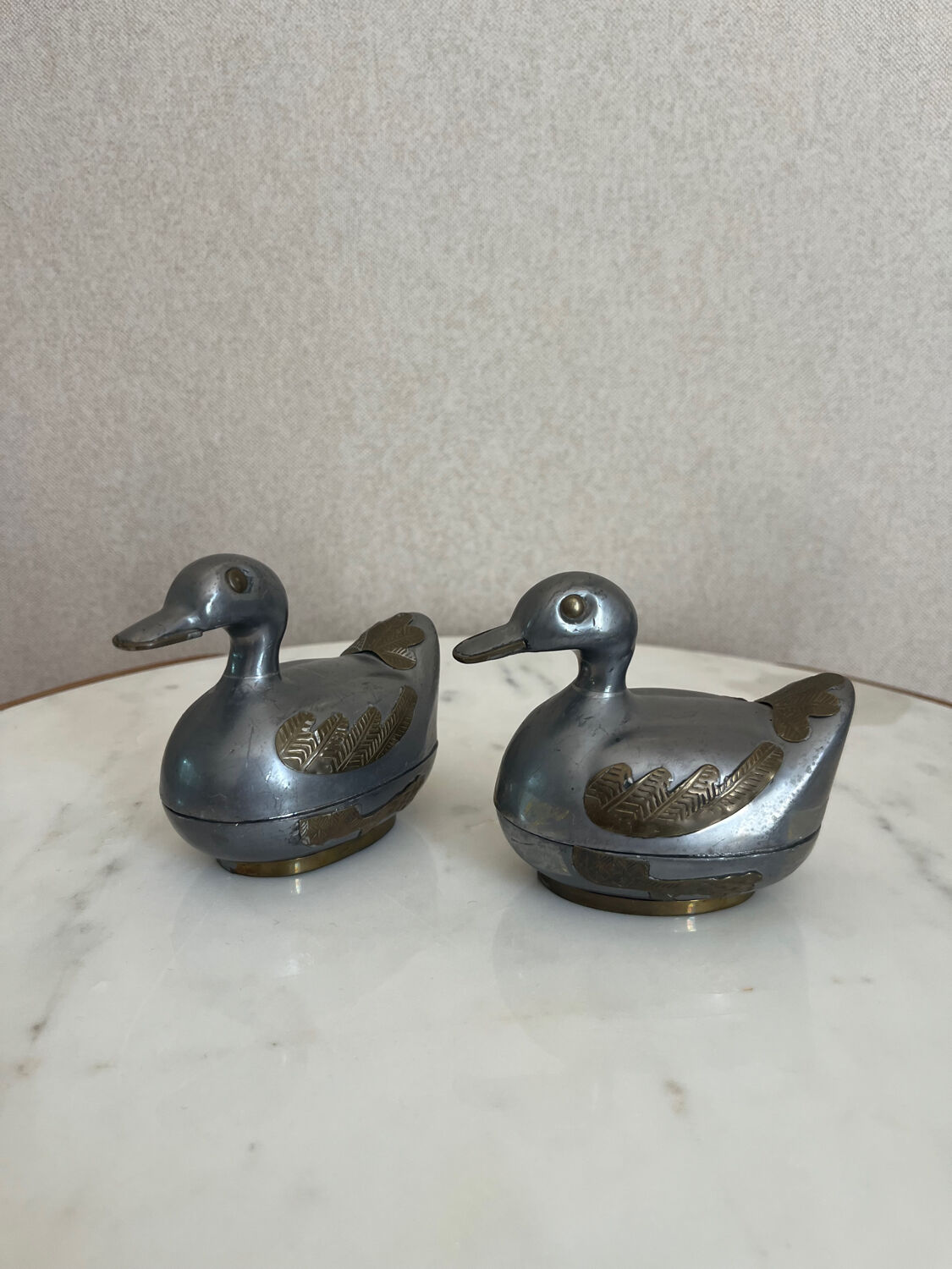 Pair of vintage decorative metal boxes in silver, shaped like ducks.