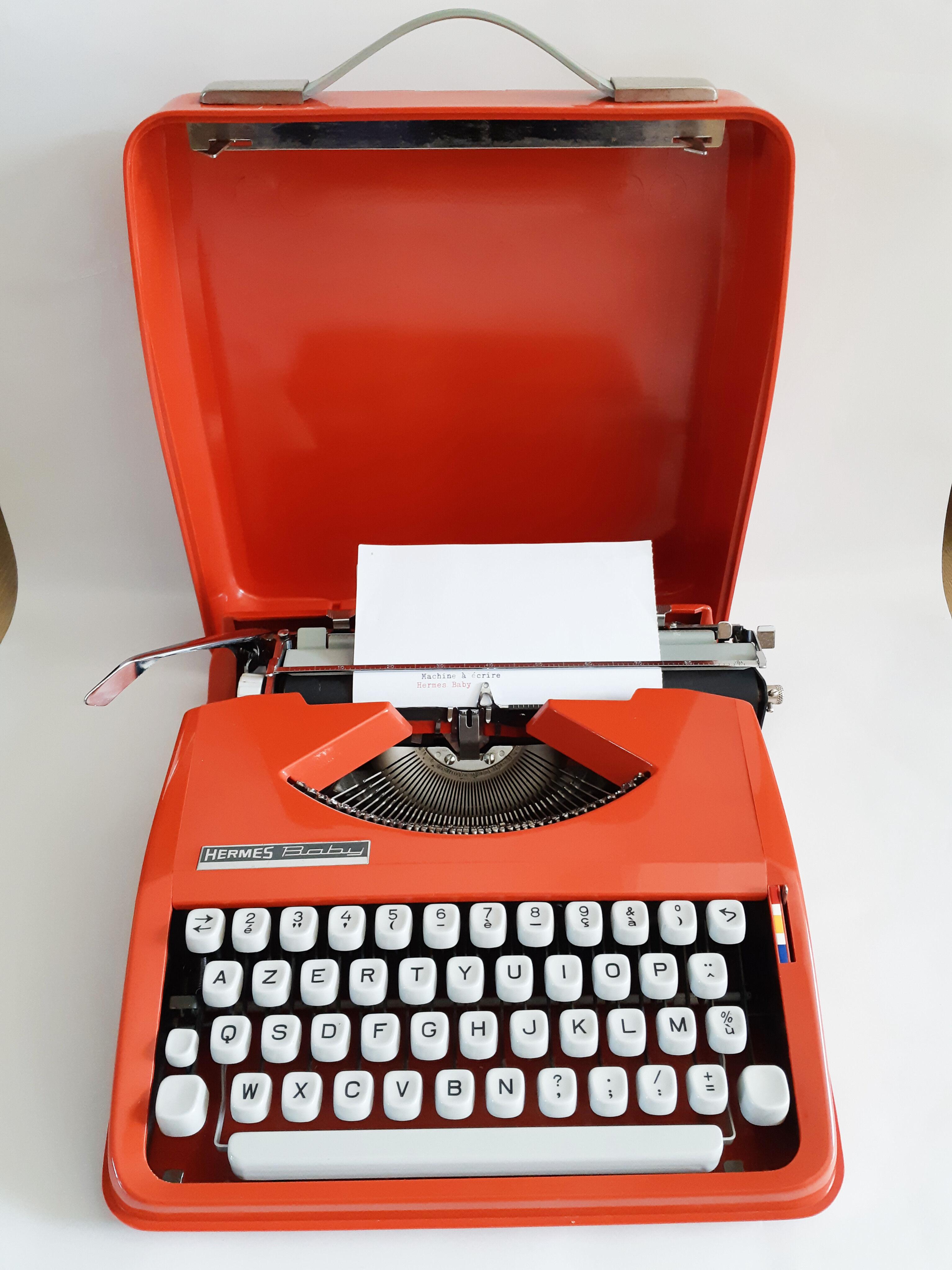 Hermes Baby orange typewriter, portable, functional