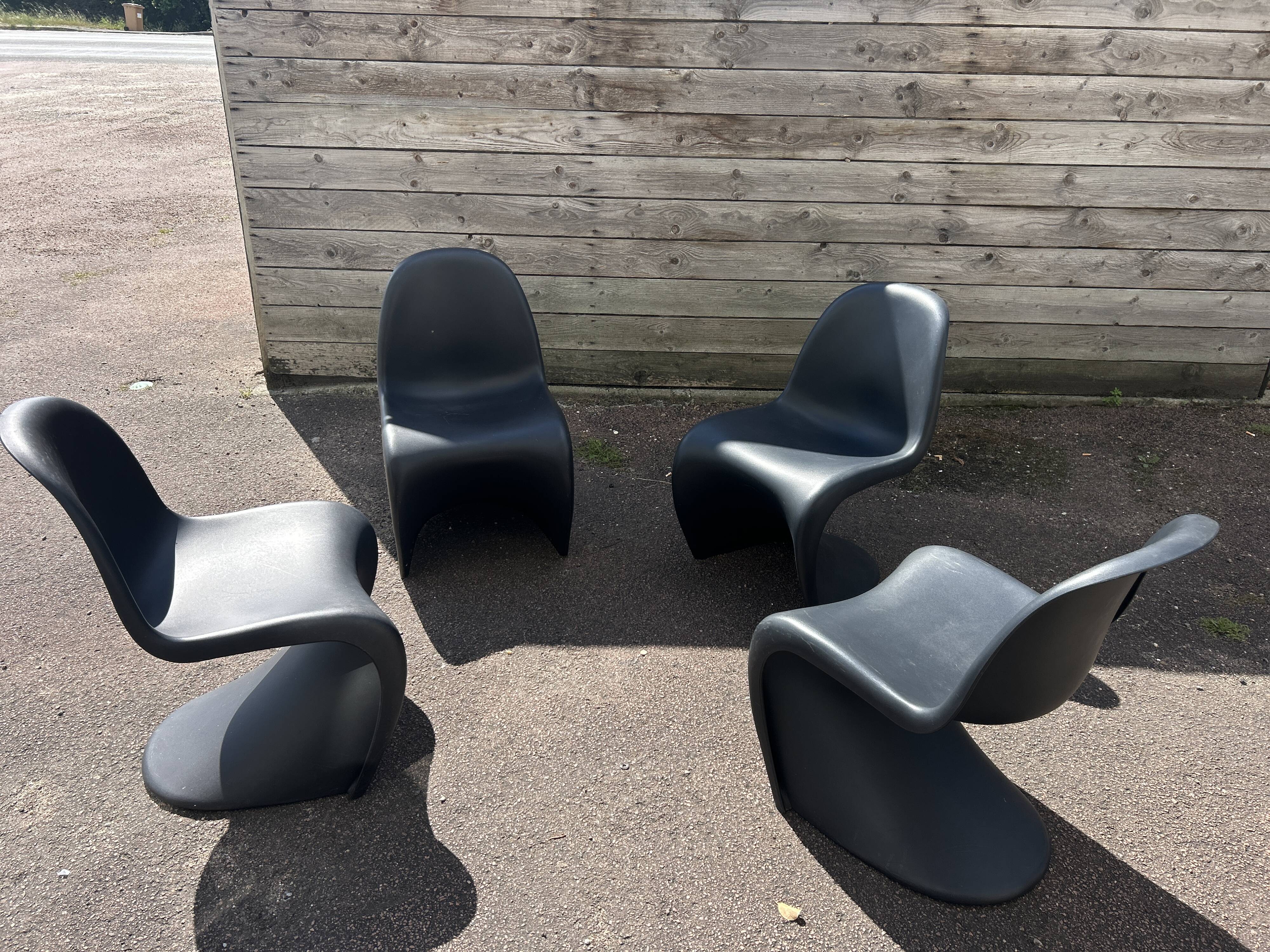 Set of 4 black Verner Panton Vitra chairs.