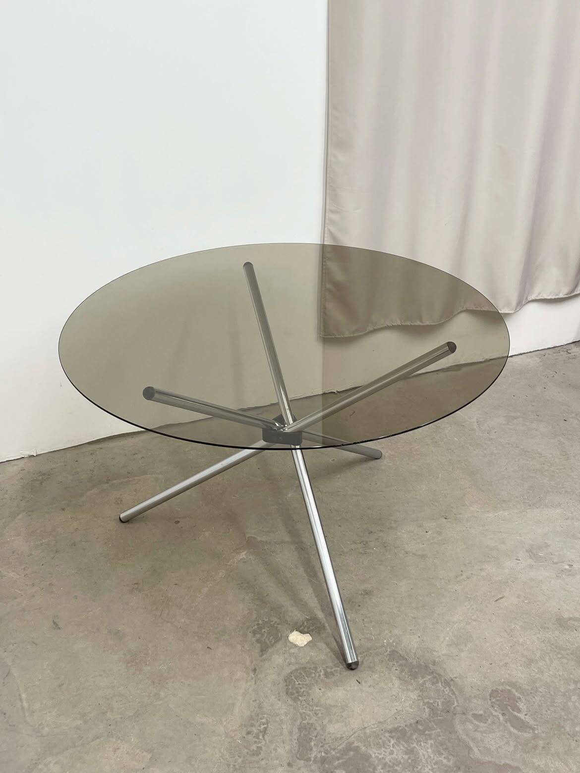Round dining table in chrome and smoked glass.