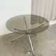 Round dining table in chrome and smoked glass.