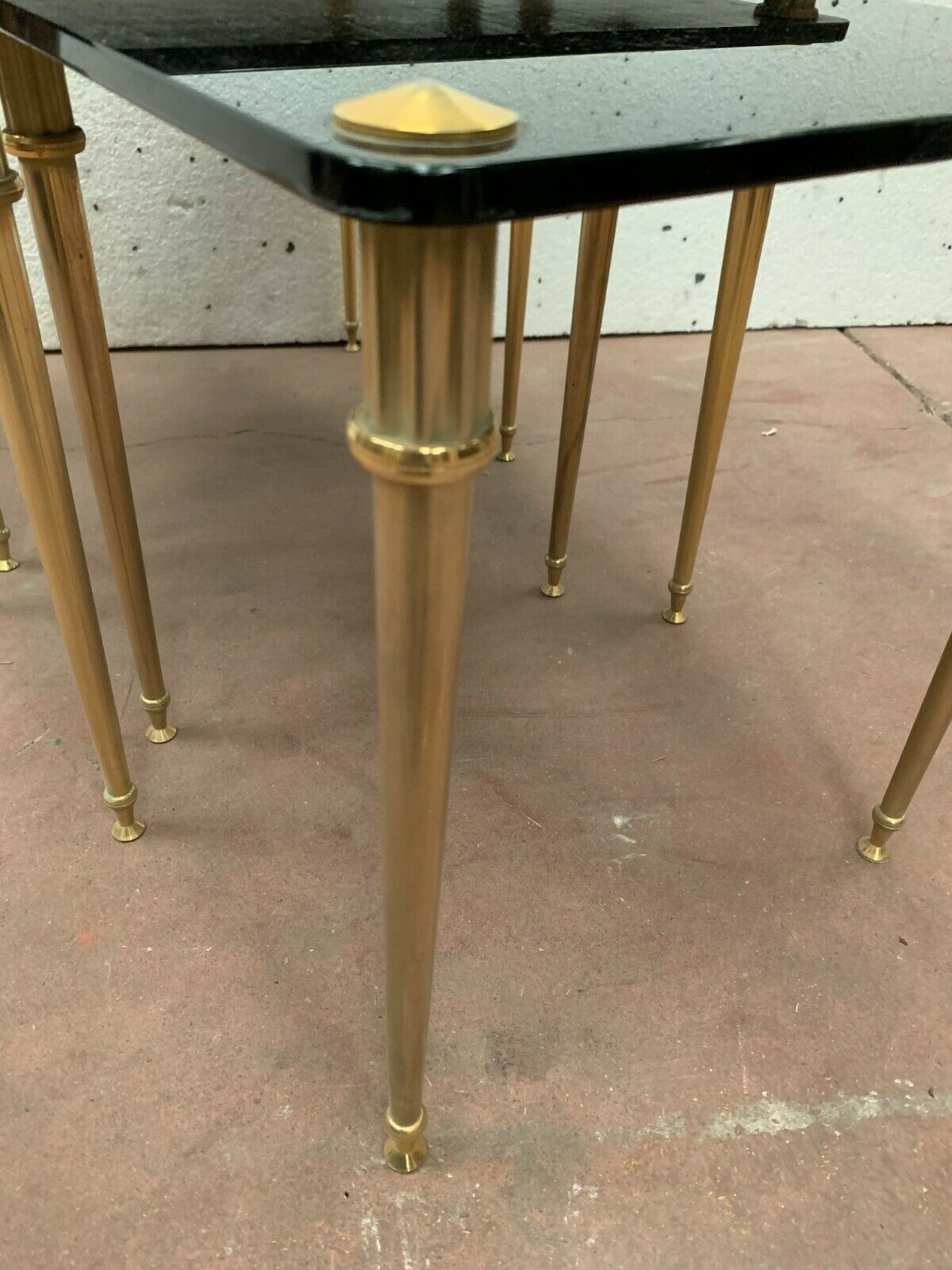 Pull out tables in brass and black glass XX century