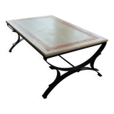 Rectangular coffee table with a stone top on wrought iron.