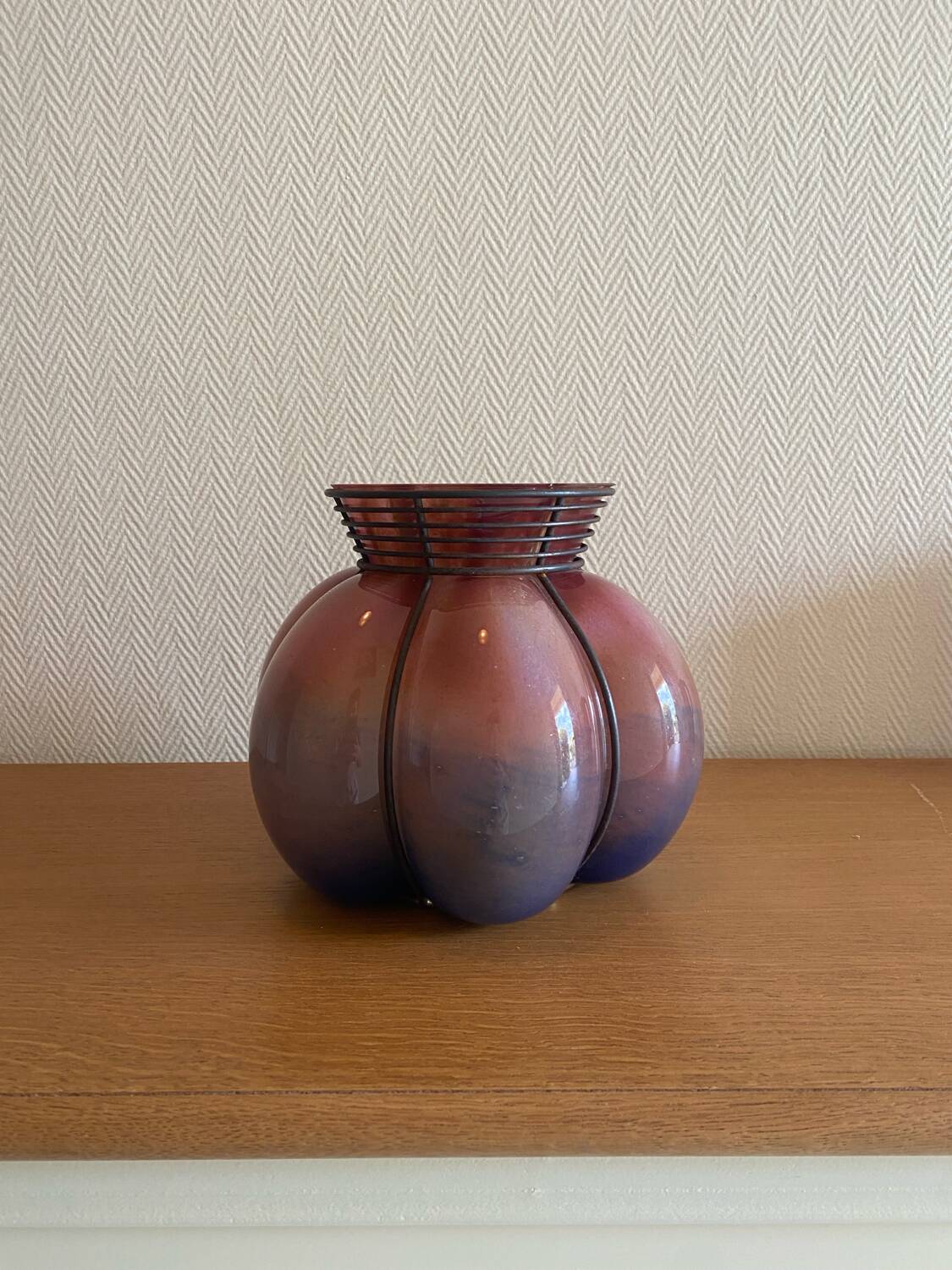Blown glass vase with metal cage