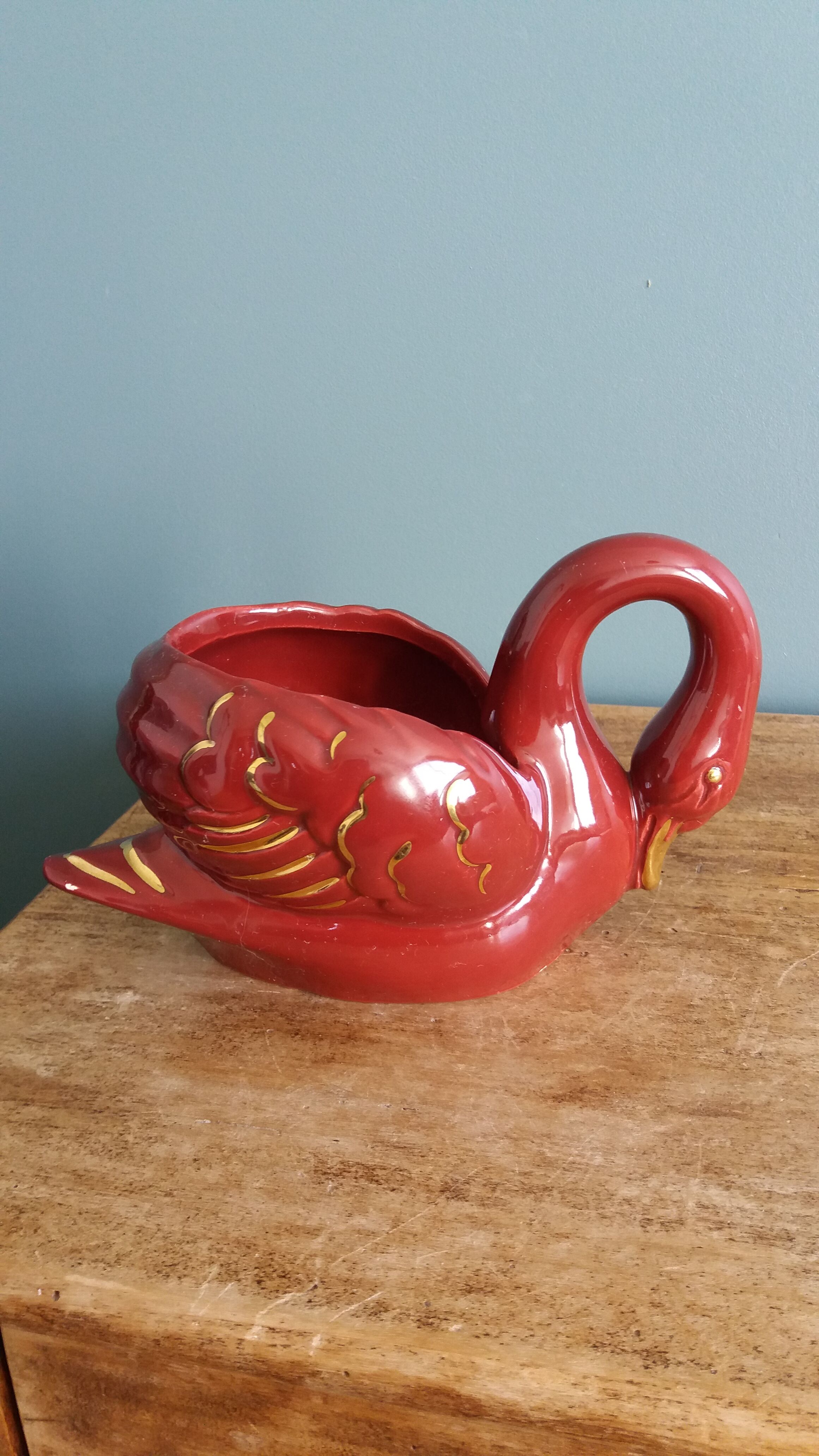 Poet Laval swan hides zoomorphic pot in burgundy ceramic.