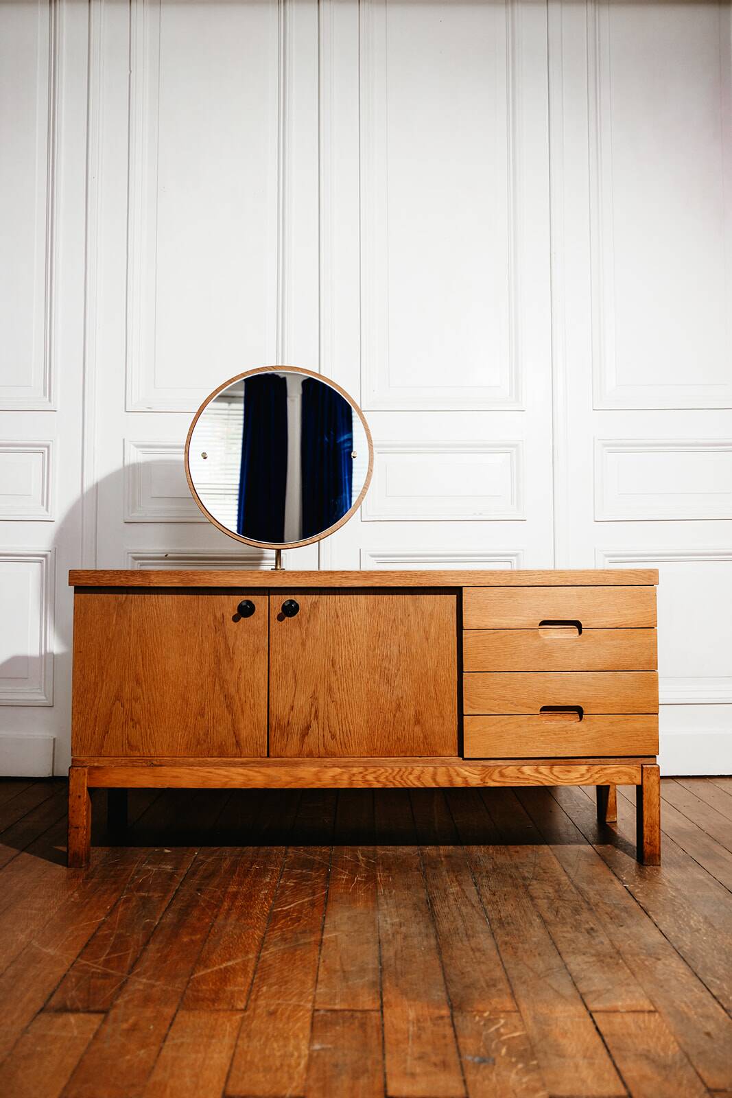 Vintage oak cabinet with circular mirror, 1960s modernist design.