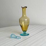 Old glass vial in yellow and blue.