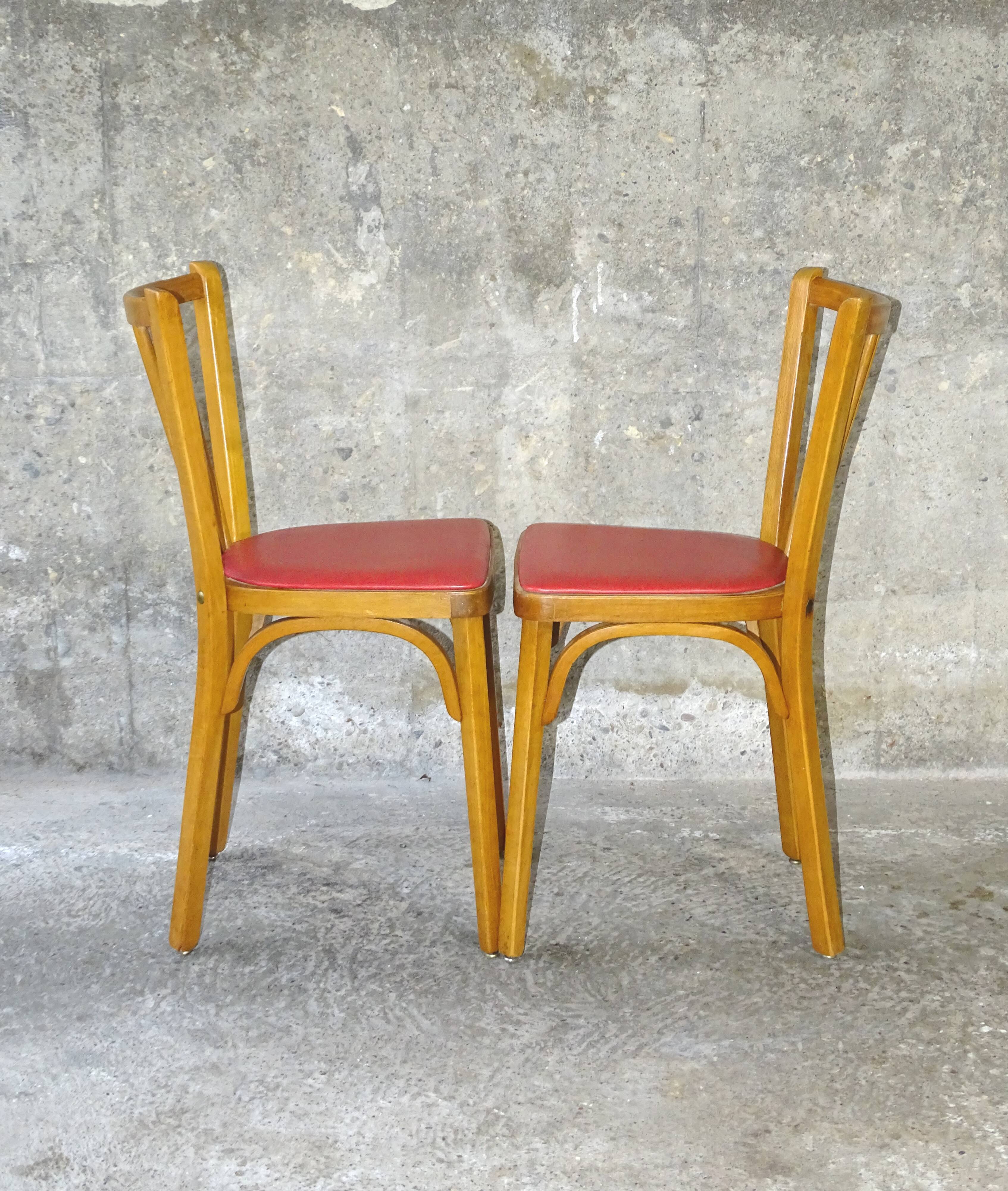 Pair of red Baumann skai chairs 1960