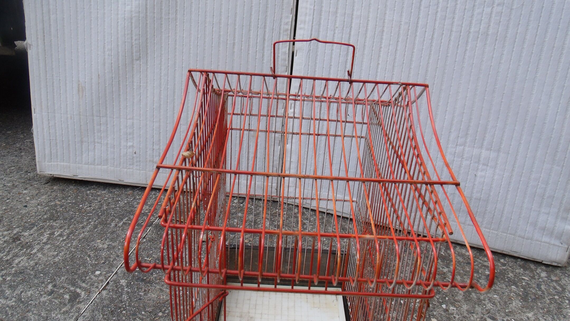 Old red metal birdcage