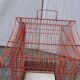 Old red metal birdcage