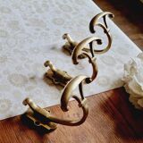Trio of brass coat hooks or coat racks
