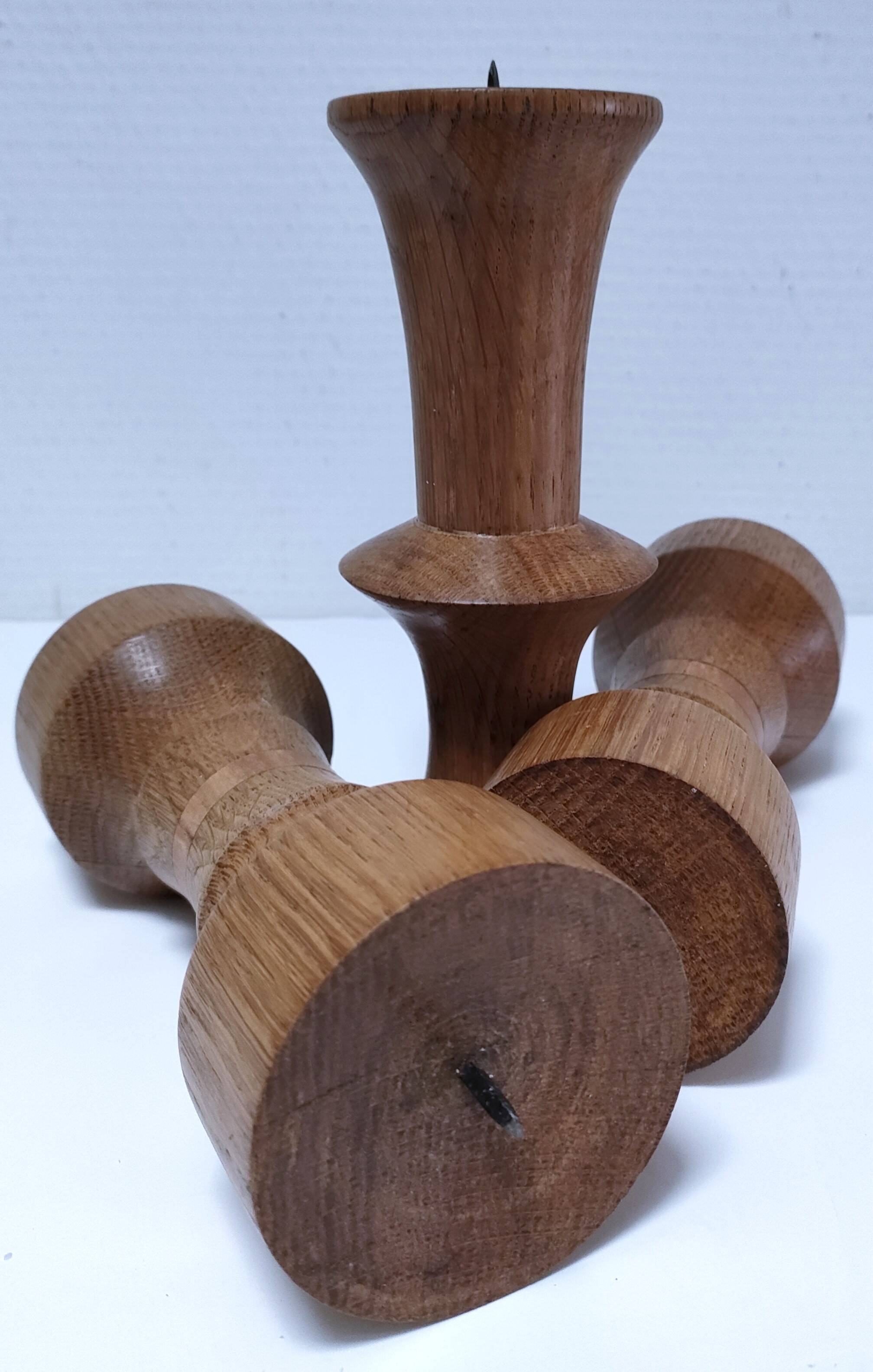 Three vintage patinated solid wood candlesticks