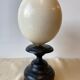 Ostrich egg on blackened wooden base