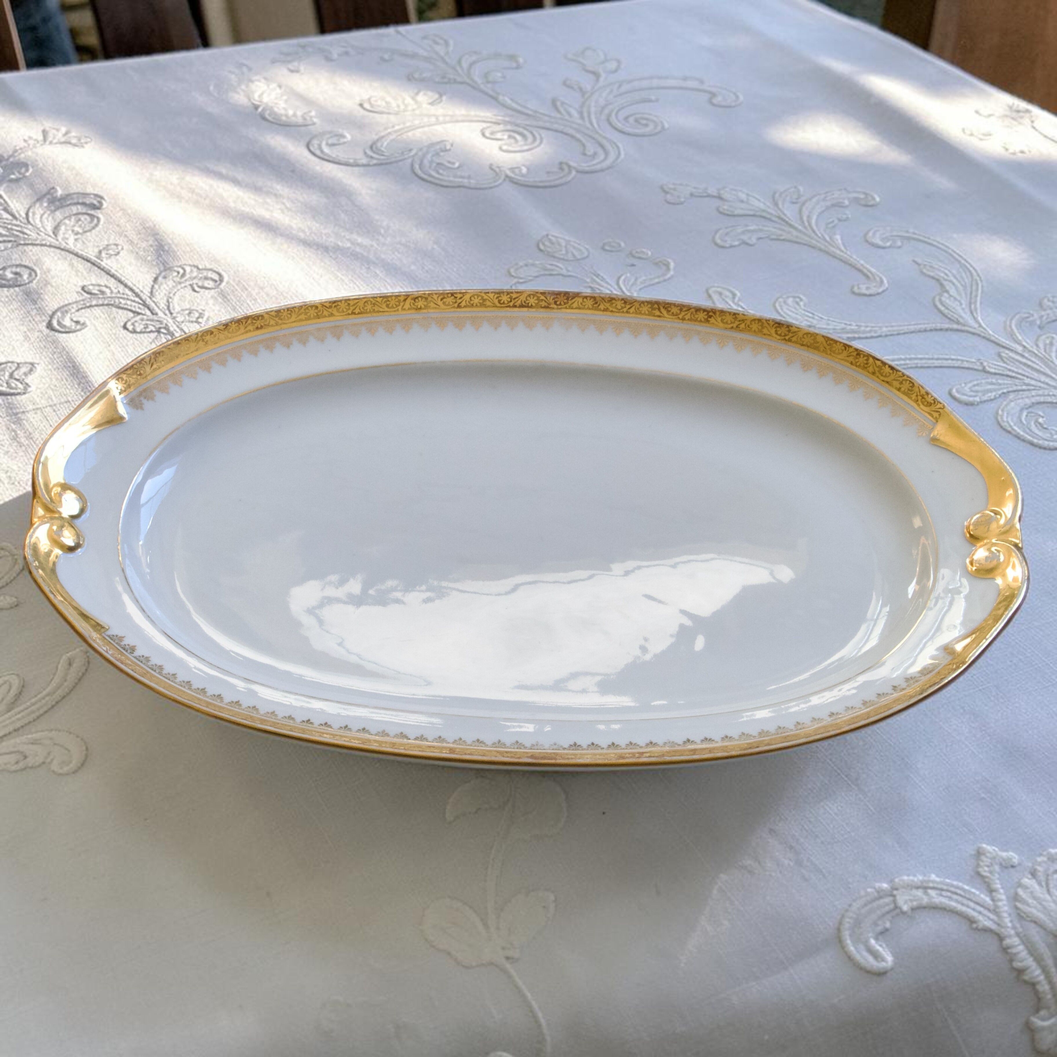 Large oval dish with gold trim in Limoges porcelain by Peconnet.