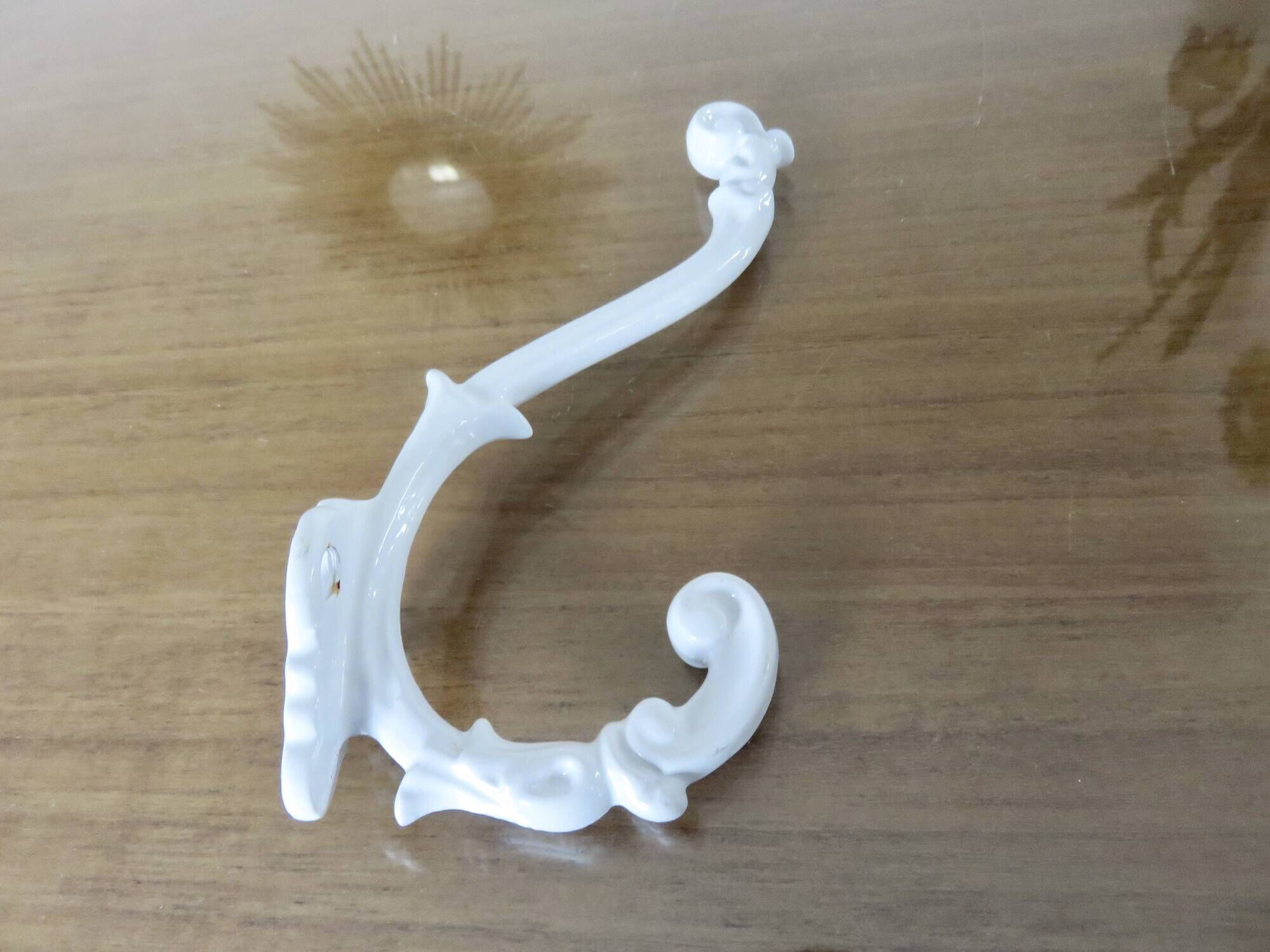 Pair of Art Deco white cast iron coat hooks from the 1930s and 1940s