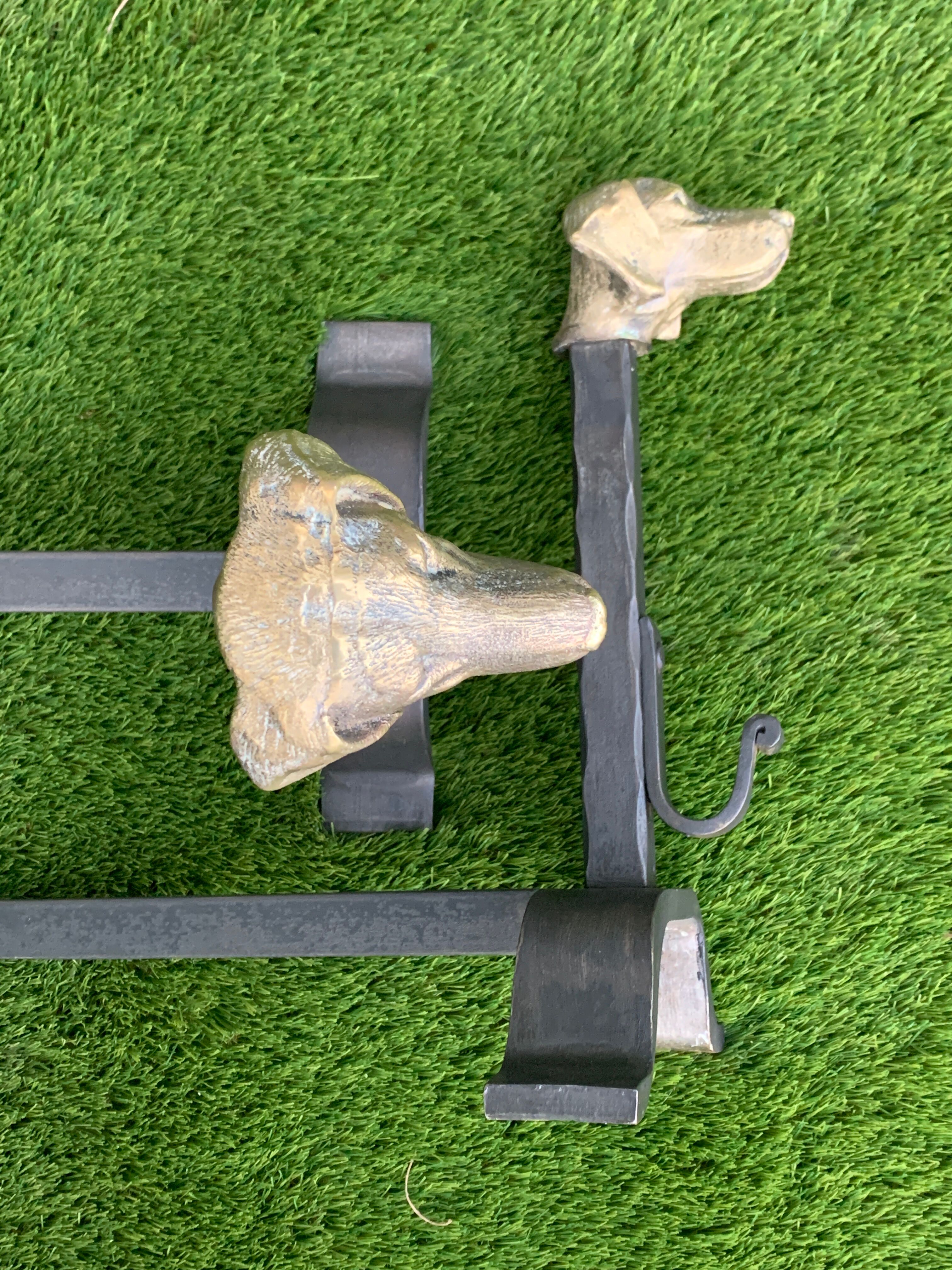 Pair of metal chenets decorated with brass dog heads