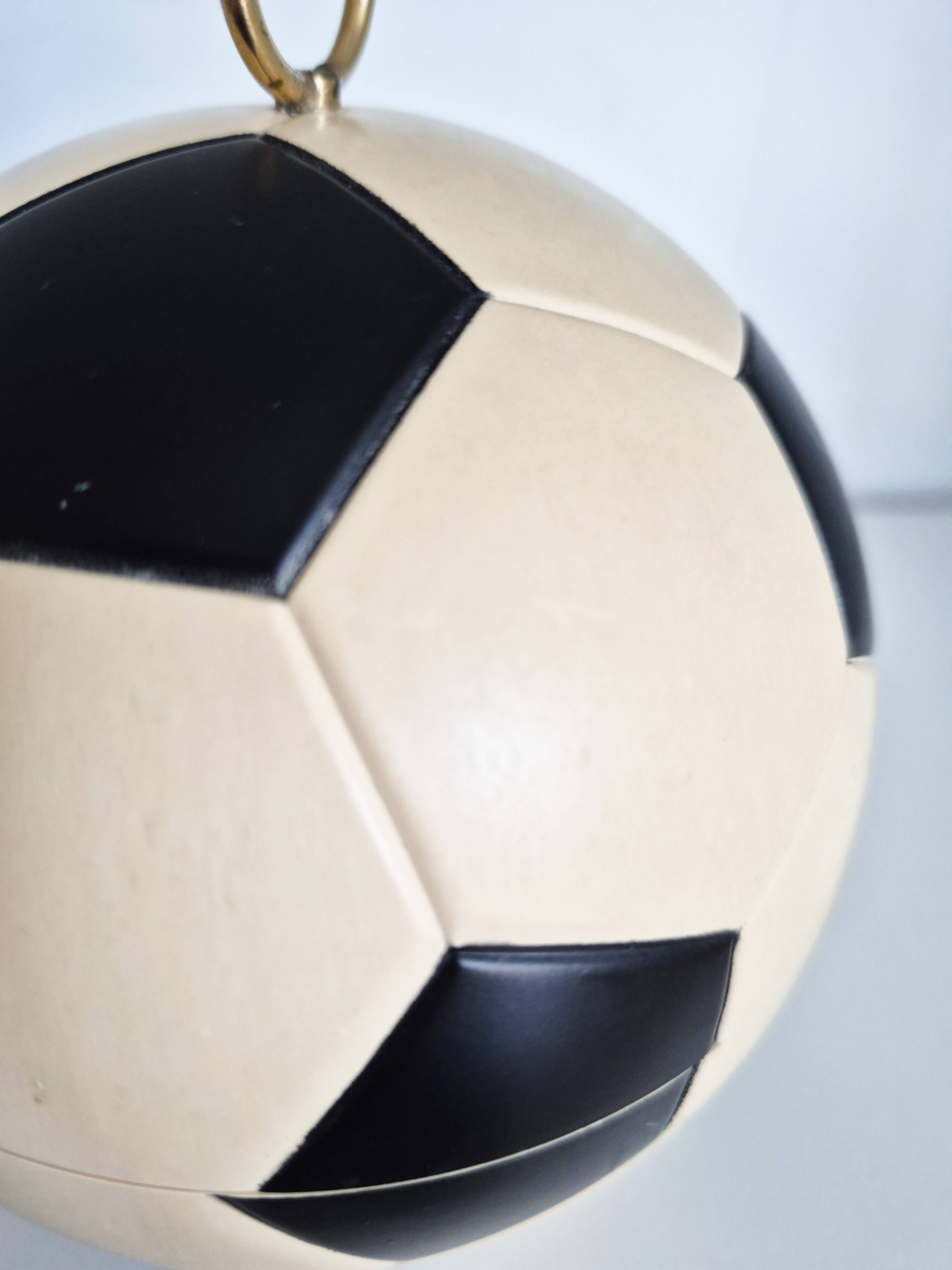 Vintage cigarette dispenser in the shape of a football.