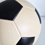 Vintage cigarette dispenser in the shape of a football.