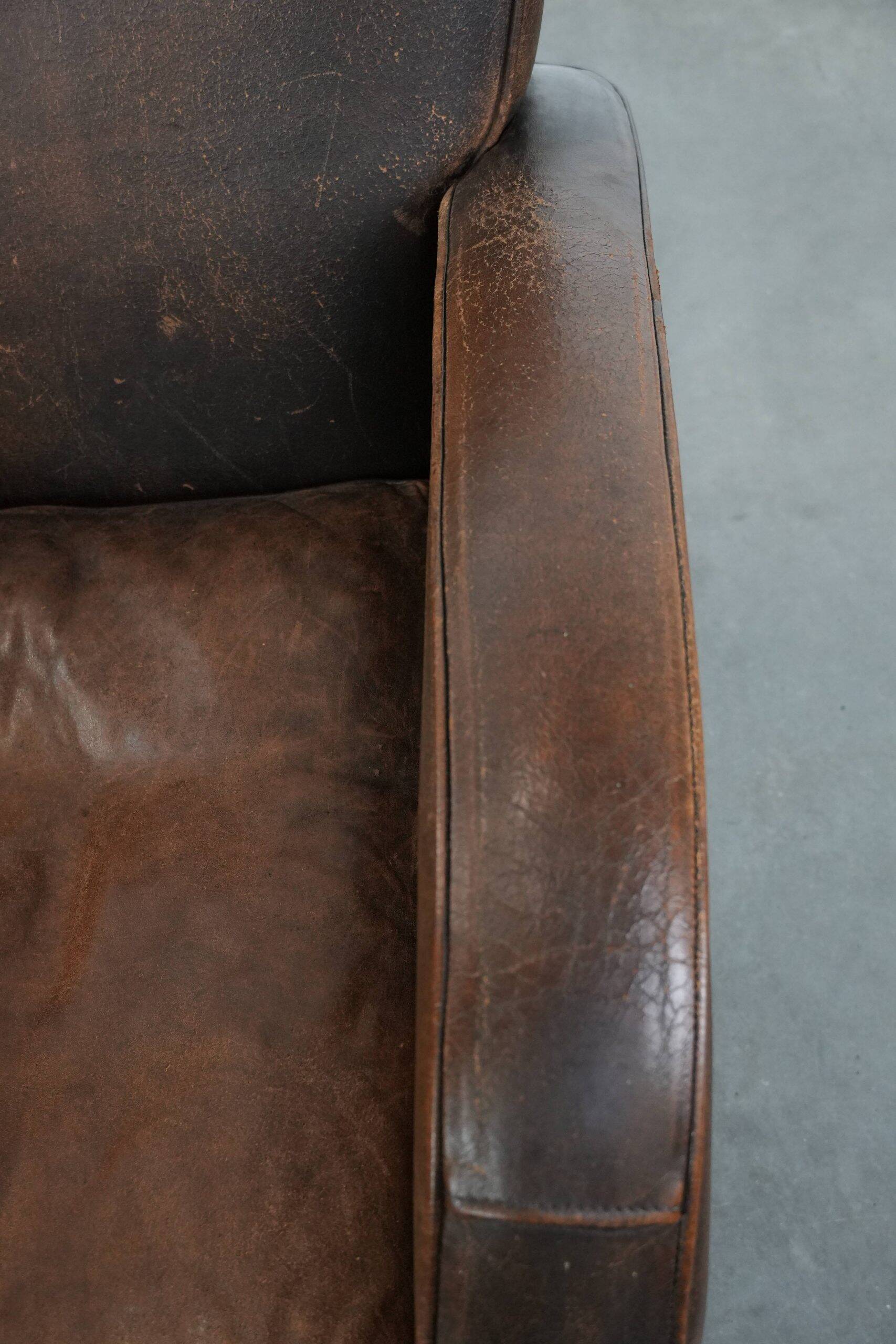 Vintage sheepskin leather design armchair in a dark cognac colour