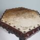 Vintage Spanish stool in carved wood with a leather seat.