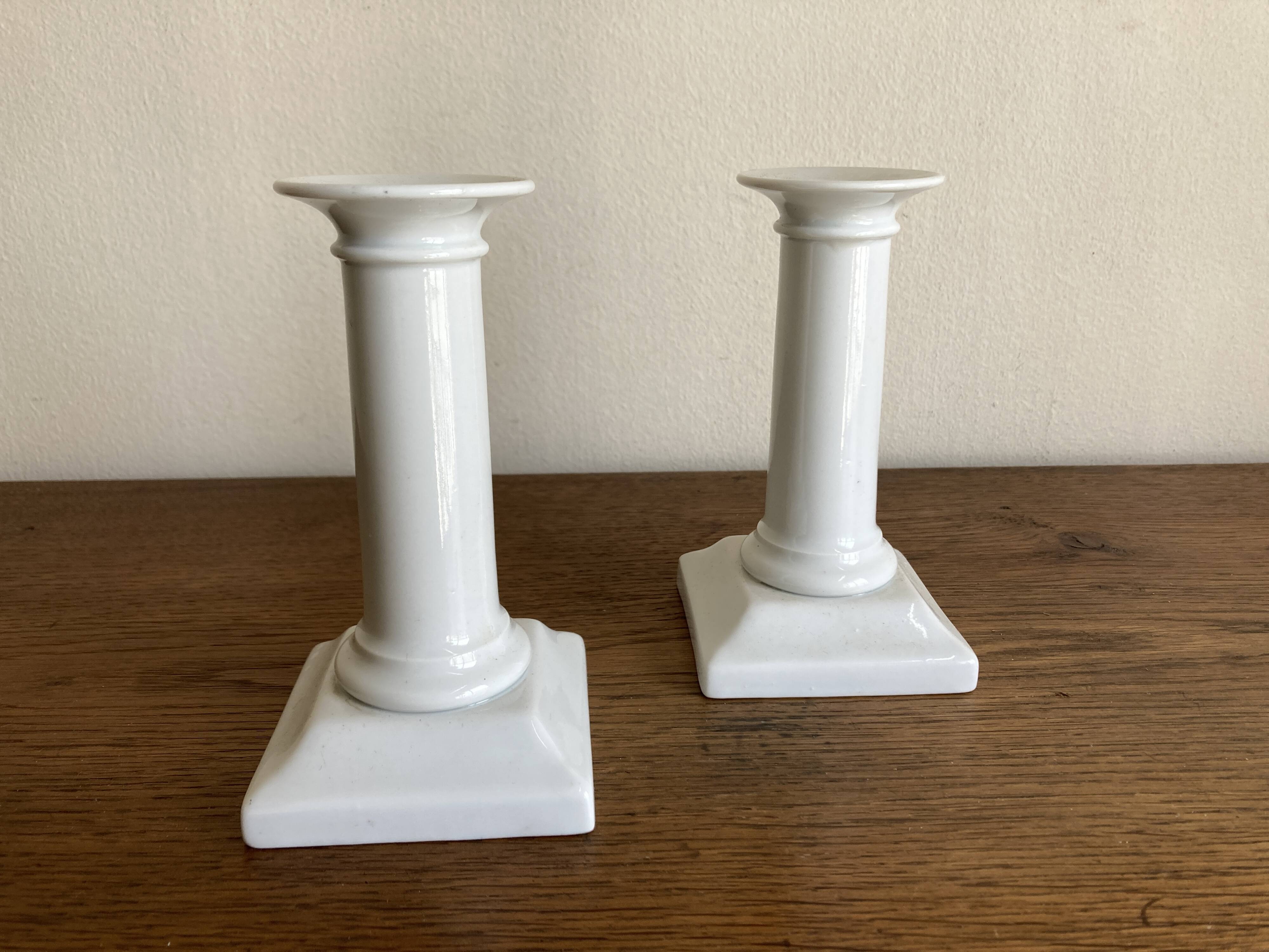 Pair of neo-classical Empire candlesticks from the late 19th century in white porcelain.