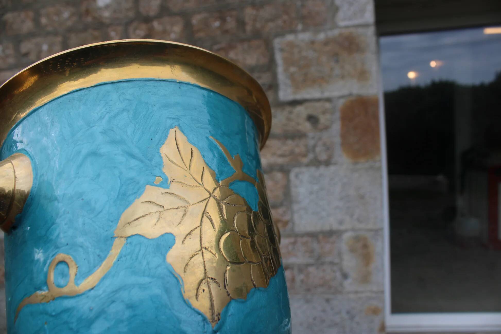 Vintage turquoise brass champagne bucket with grape decoration.