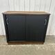 Small vintage black buffet with sliding doors.