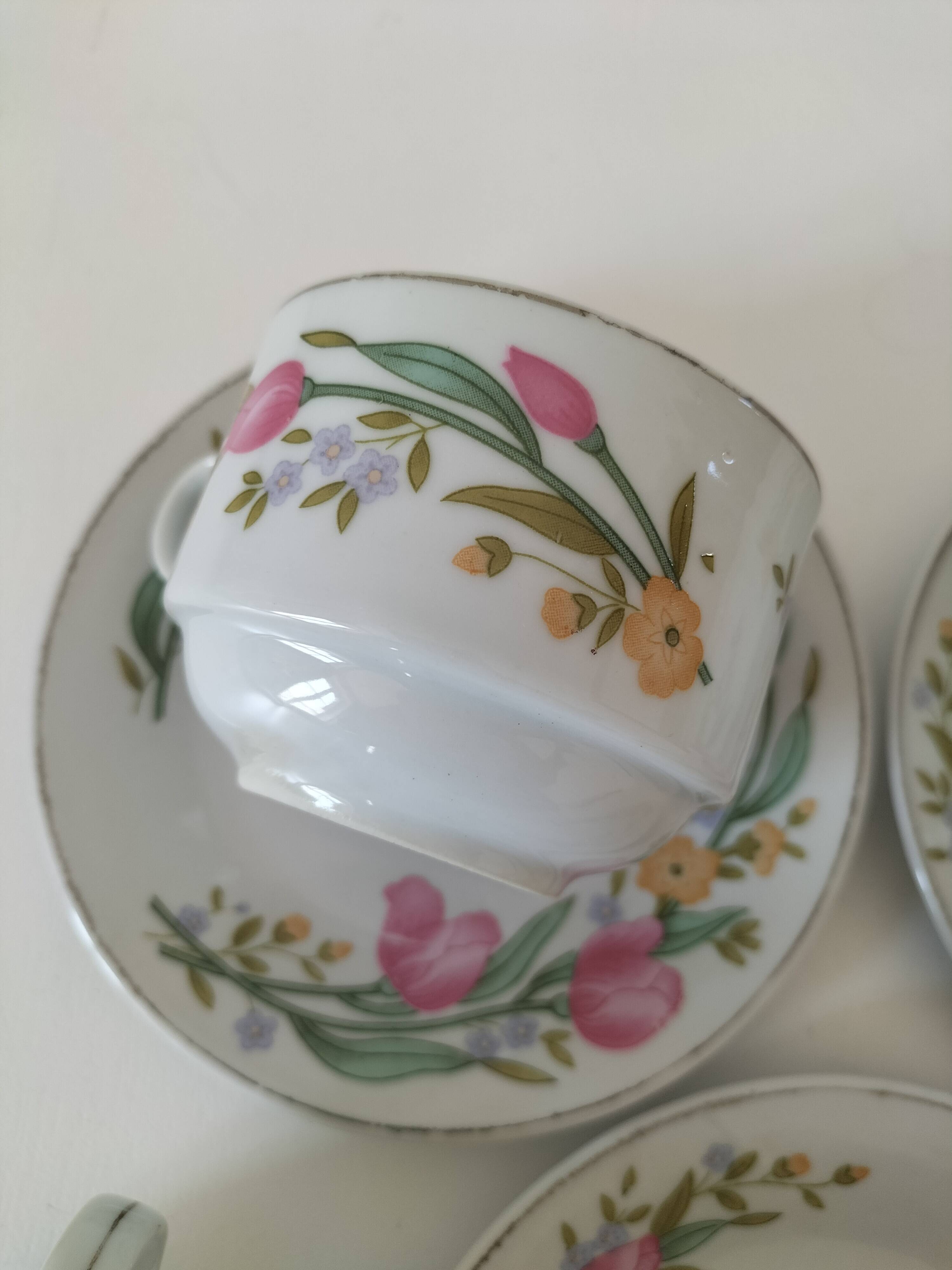 Trio of floral porcelain cups and saucers