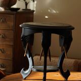 Side table in hardwood ebony with three elephant head-shaped legs, Eastern India, 1920s.