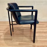 Design armchair in leather and metal.