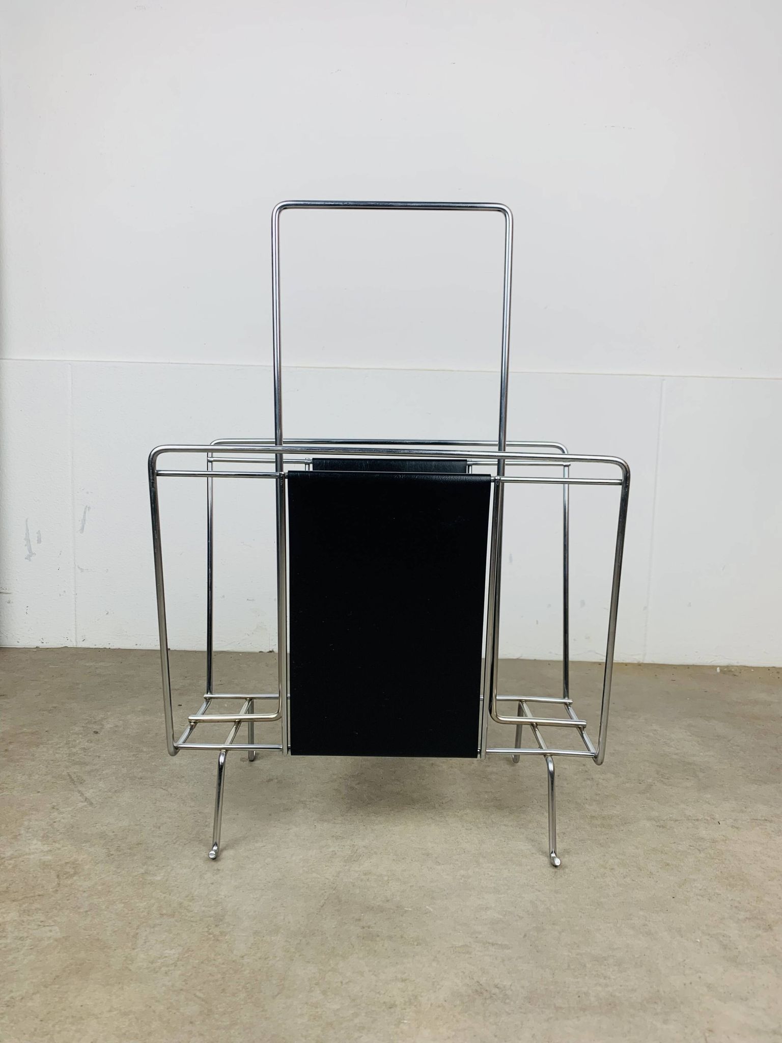 Chrome and black leather magazine rack, 1970s.