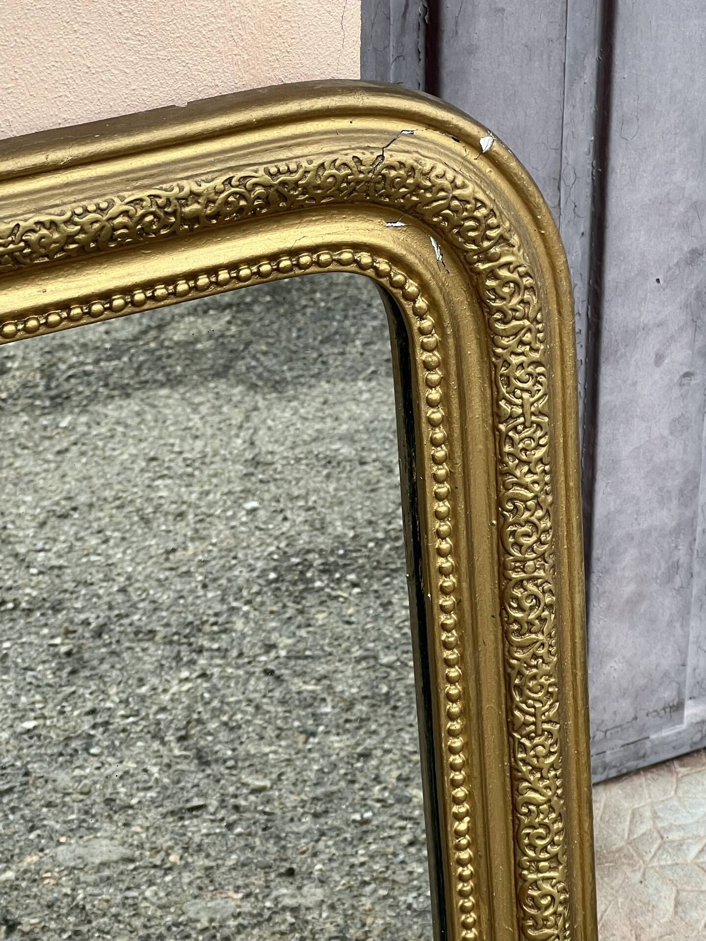 Louis Philippe mirror in gilded wood with an openwork frieze and mercury glass.