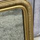 Louis Philippe mirror in gilded wood with an openwork frieze and mercury glass.