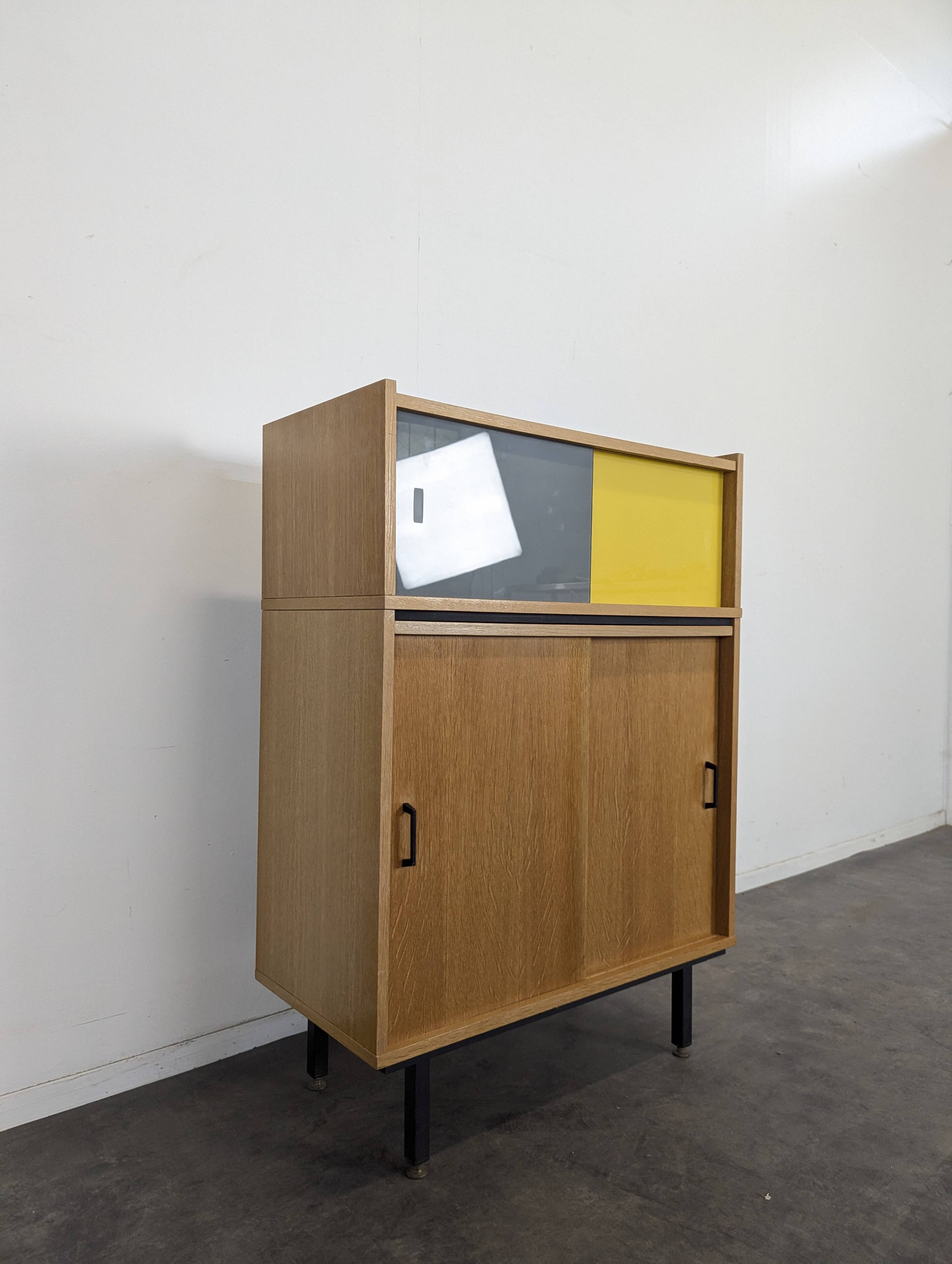 Modernist sideboard with glass doors in grey and yellow oak veneer.