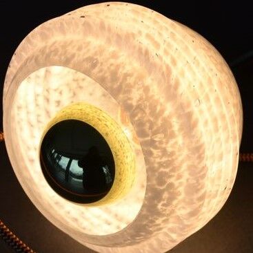 White Clichy glass globe wall light, porcelain support and gooseneck stem in brass