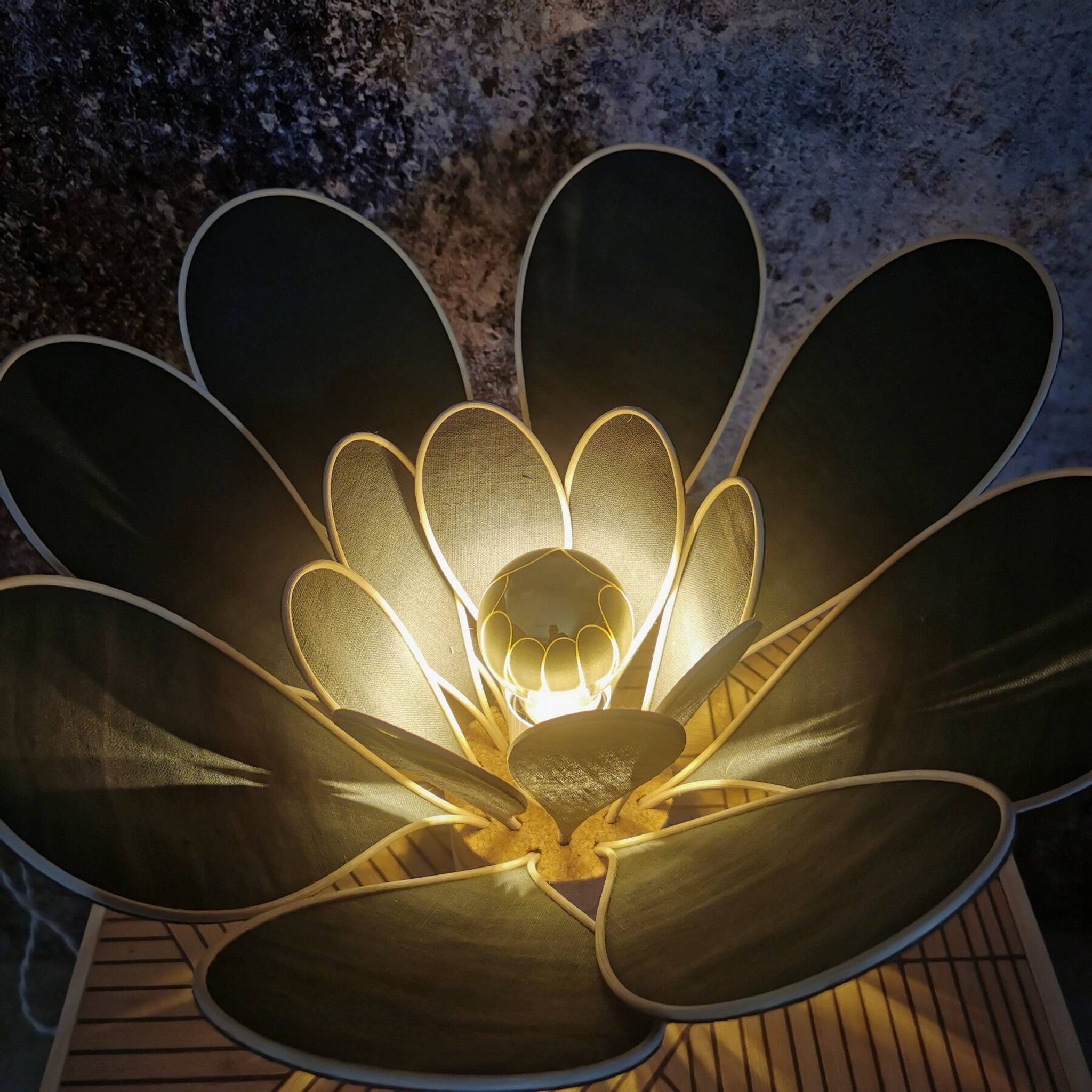 Flower table lamp made of rattan and fir green linen petals